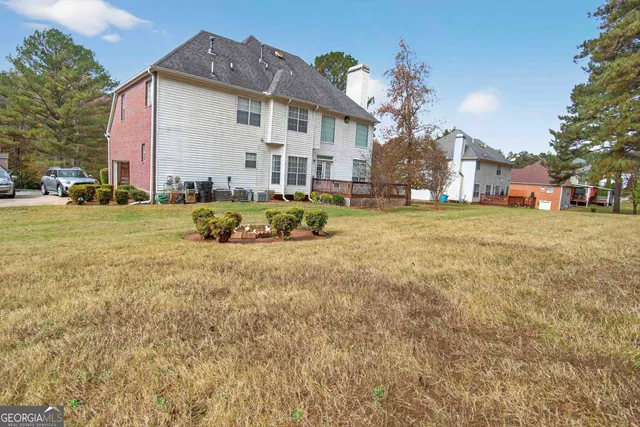 a view of a patio with table and chairs with wooden floor and fence
