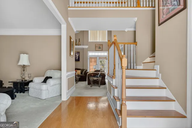 a living room with furniture a window and a lamp