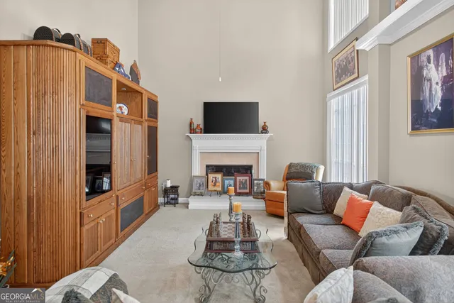 a kitchen with stainless steel appliances kitchen island granite countertop a table chairs and a refrigerator