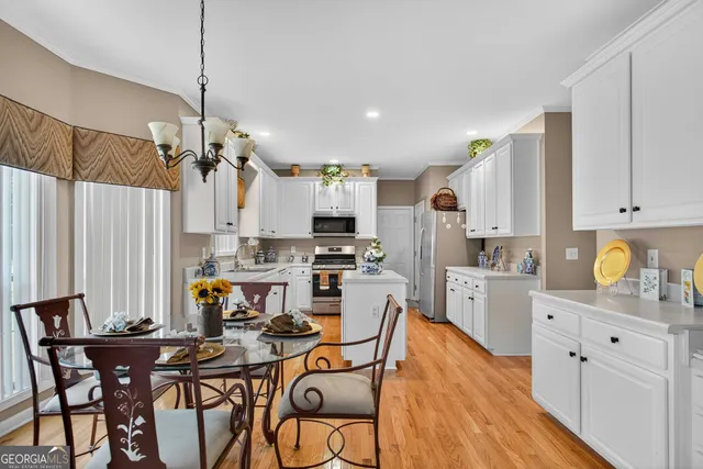 a view of a dining room with furniture wooden floor and chandelier