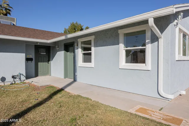 a view of a house with a backyard