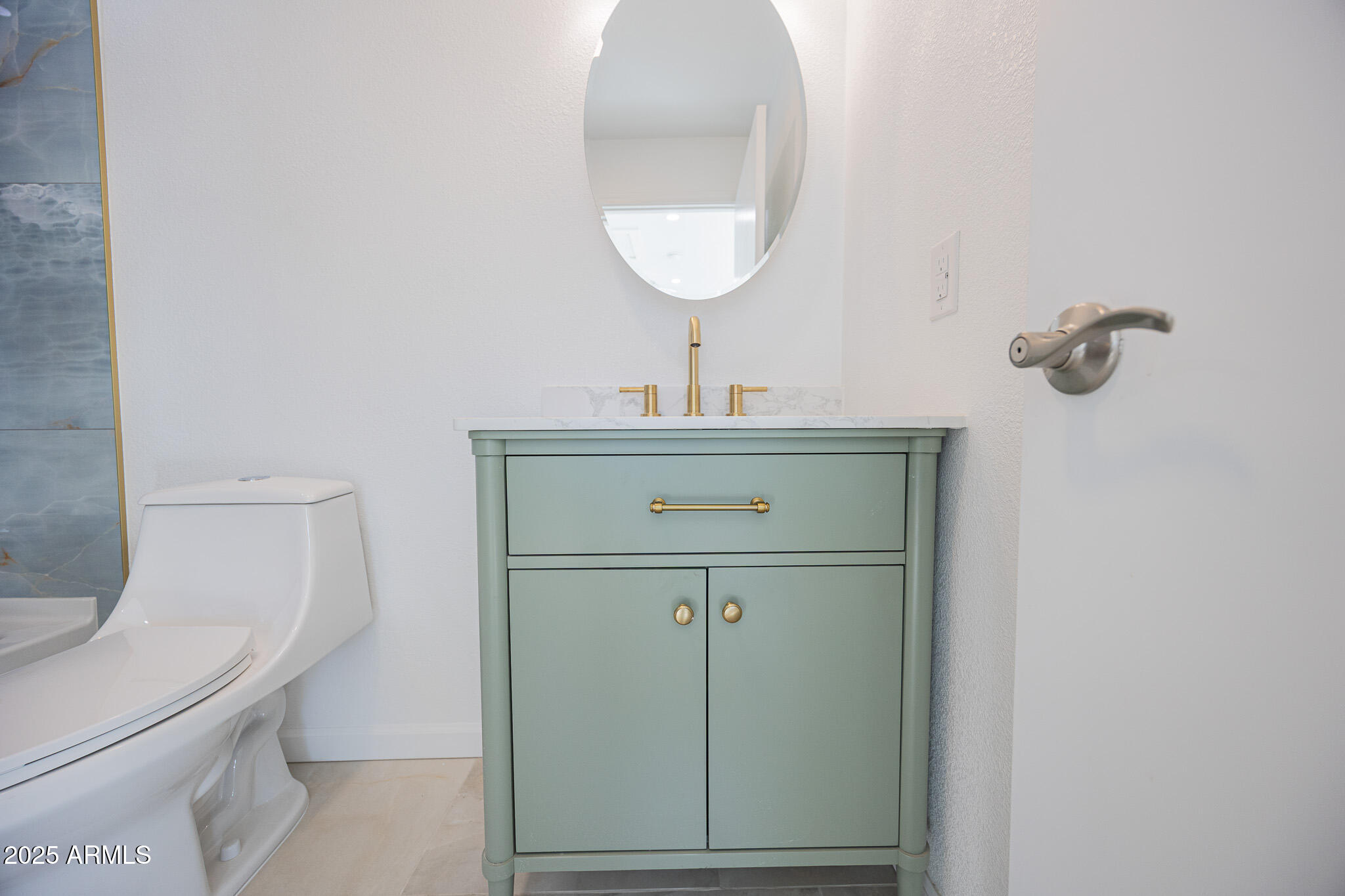 5132 South Dorsey Lane, Unit A Tempe, AZ 85282 - Photo 12 of 15 a bathroom with a toilet a sink and mirror