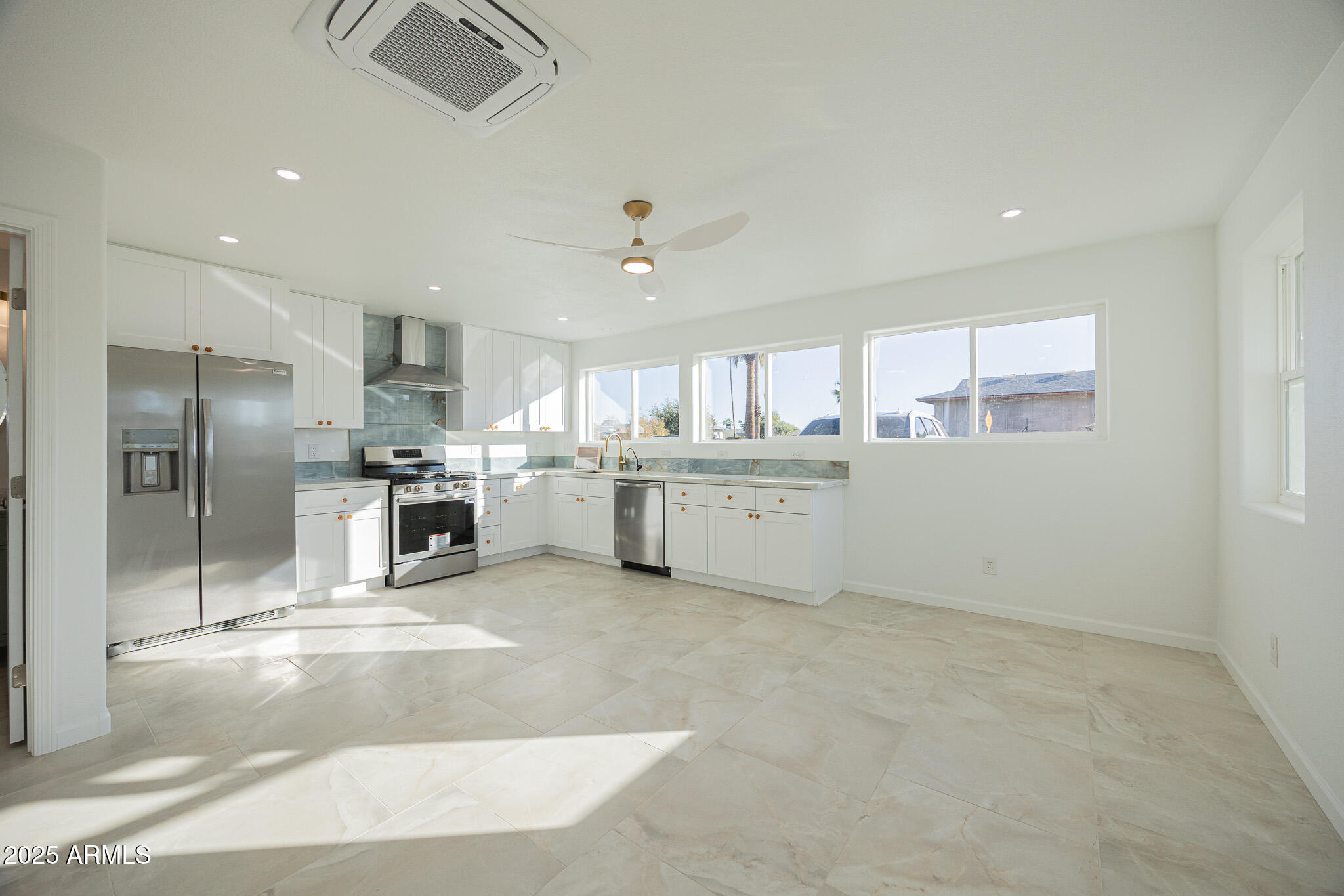 5132 South Dorsey Lane, Unit A Tempe, AZ 85282 - Photo 4 of 15 a kitchen with stainless steel appliances kitchen island granite countertop a stove a sink and a refrigerator