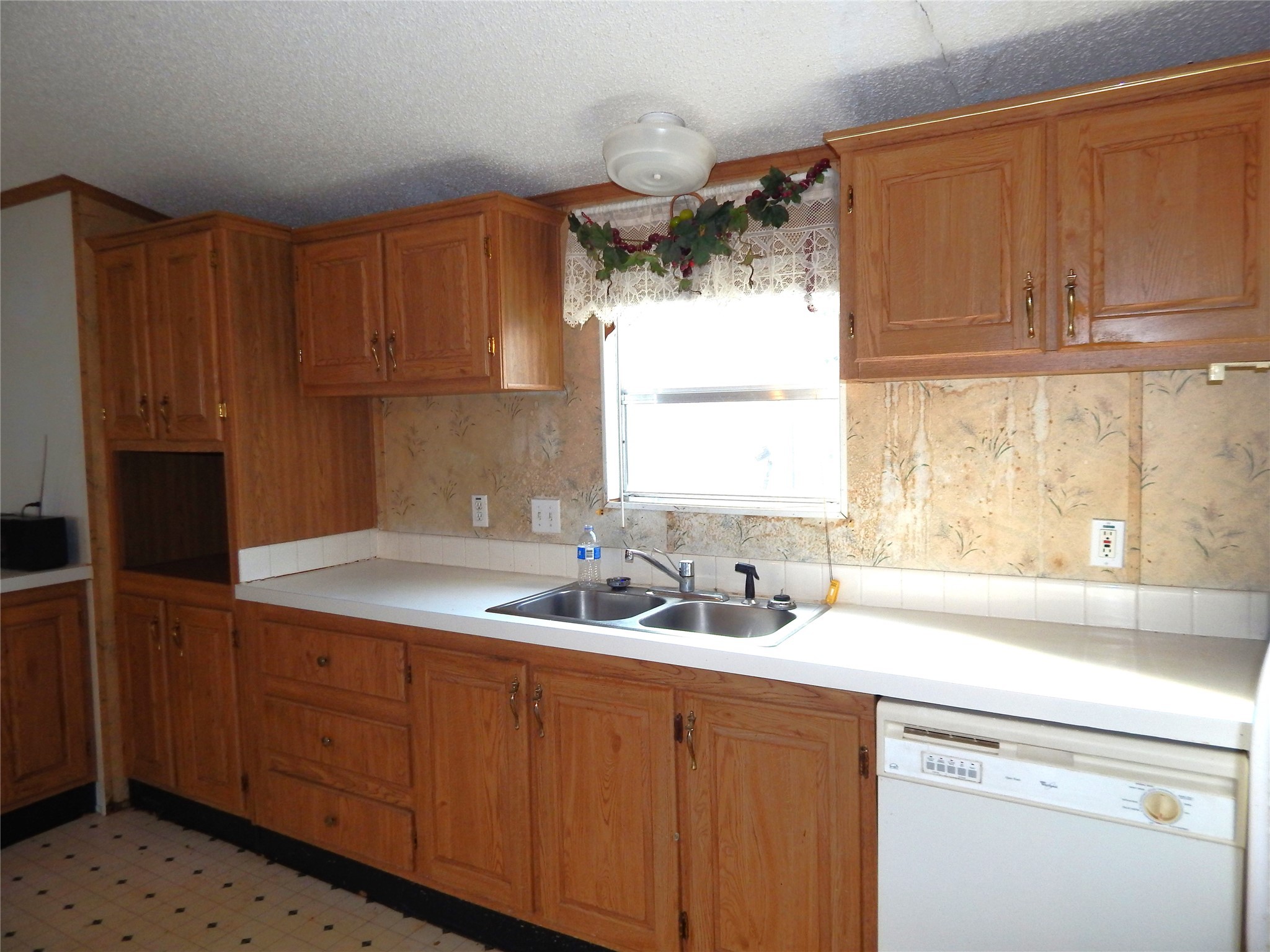 9343 Greens Road Humble, TX 77396 - Photo 11 of 16 a kitchen with a sink cabinets and window
