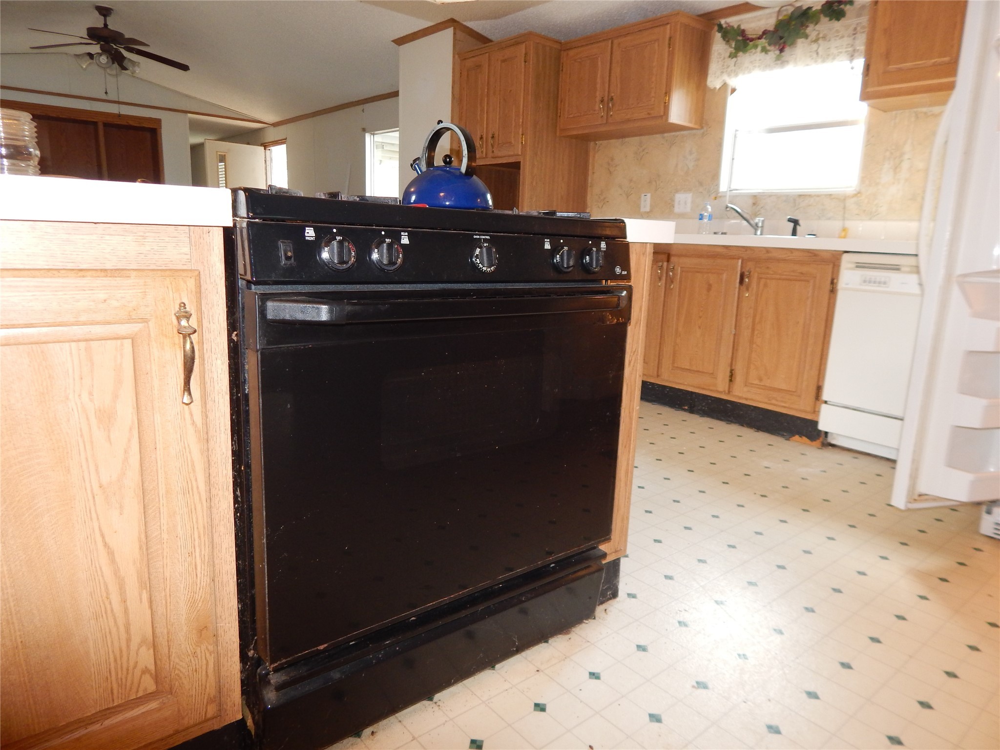 9343 Greens Road Humble, TX 77396 - Photo 10 of 16 a kitchen with a stove and a refrigerator