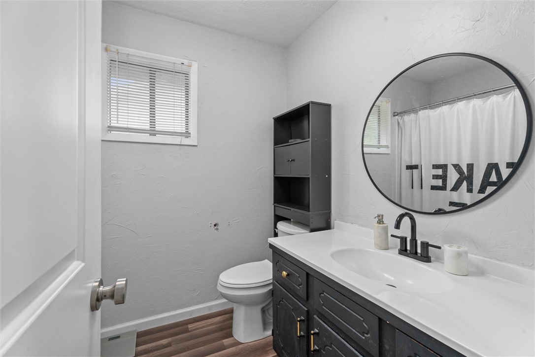 3511 Pecos Court Bryan, TX 77801 - Photo 17 of 22 a bathroom with a toilet a sink and mirror