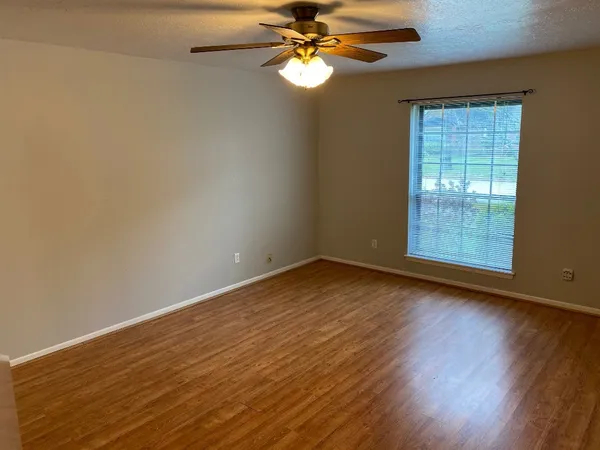 a view of a livingroom with wooden floor and a sink