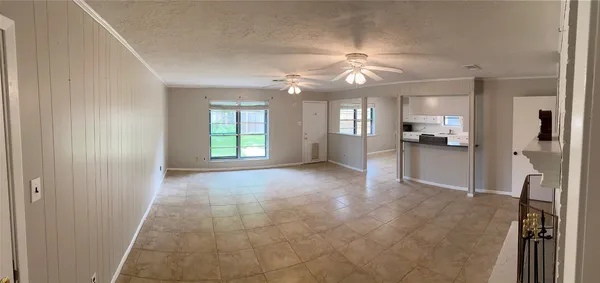 a view of a livingroom with a ceiling fan and window