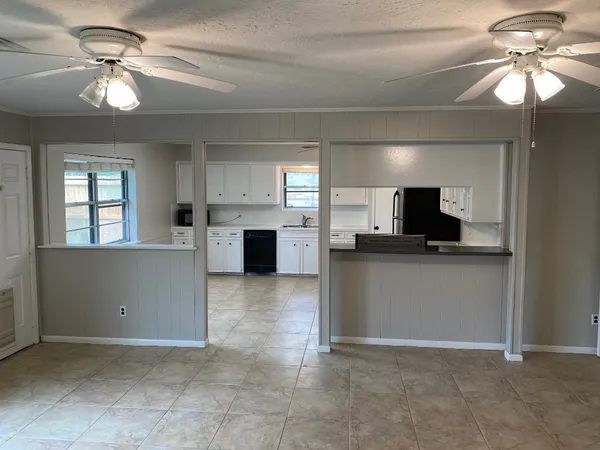 a kitchen with a stove a sink and a window