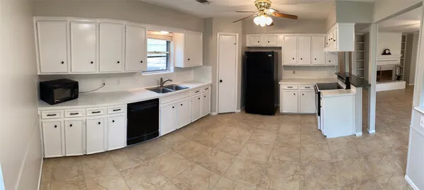 a view of a livingroom with a fireplace and a ceiling fan