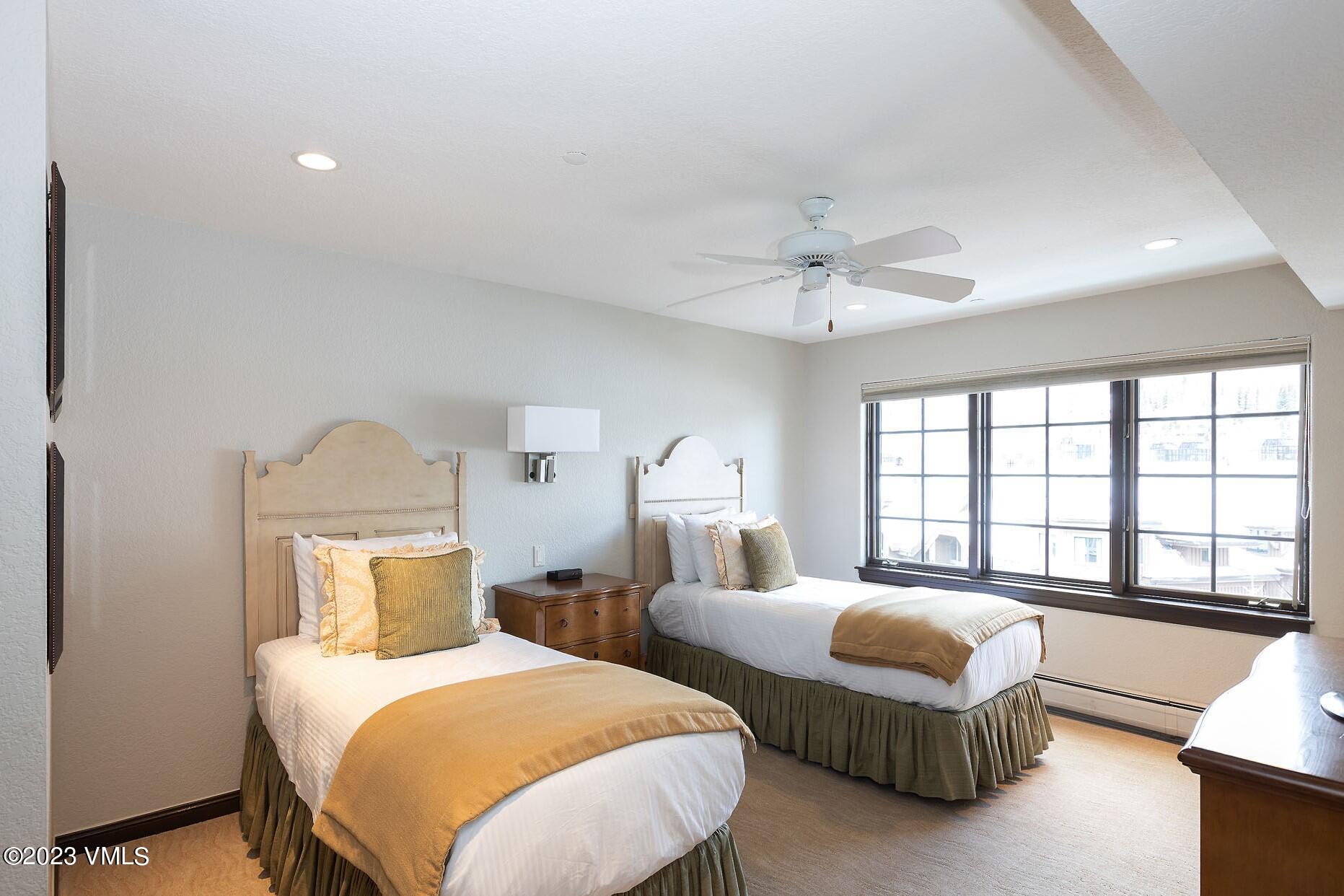 210 Offerson Road, Unit R121 WEEK 4 Beaver Creek, CO 81620 - Photo 7 of 23 a bedroom with two beds and a large window