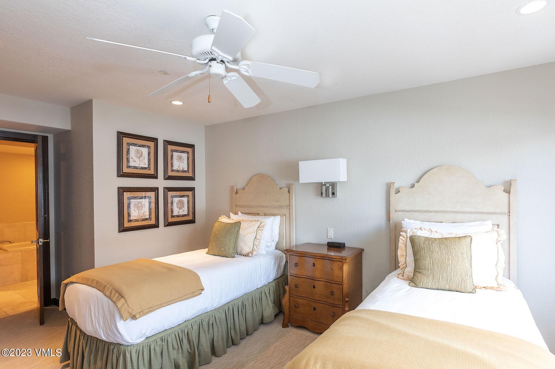 210 Offerson Road, Unit R121 WEEK 4 Beaver Creek, CO 81620 - Photo 8 of 23 a bedroom with a large bed and a chandelier