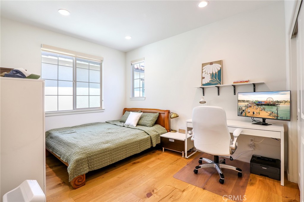 981 Rodeo Road Pomona, CA 91766 - Photo 35 of 47 a bedroom with a bed and wooden floor