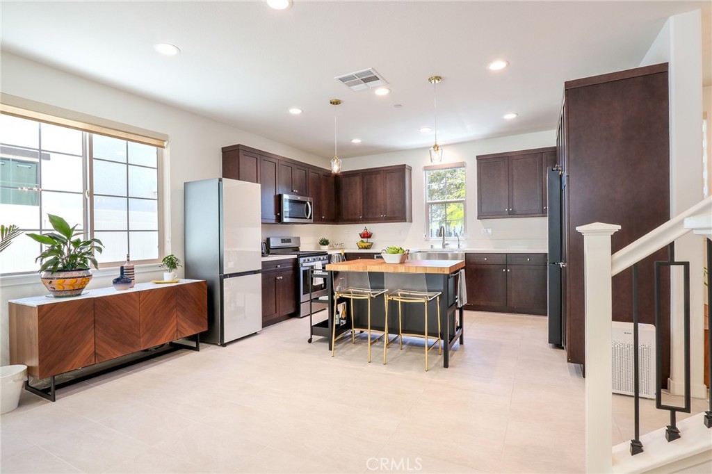 981 Rodeo Road Pomona, CA 91766 - Photo 5 of 47 a living room with stainless steel appliances kitchen island granite countertop furniture and a refrigerator