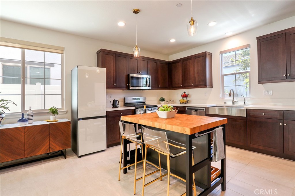 981 Rodeo Road Pomona, CA 91766 - Photo 7 of 47 a kitchen with stainless steel appliances granite countertop a refrigerator a sink dishwasher a stove and a refrigerator with wooden floor