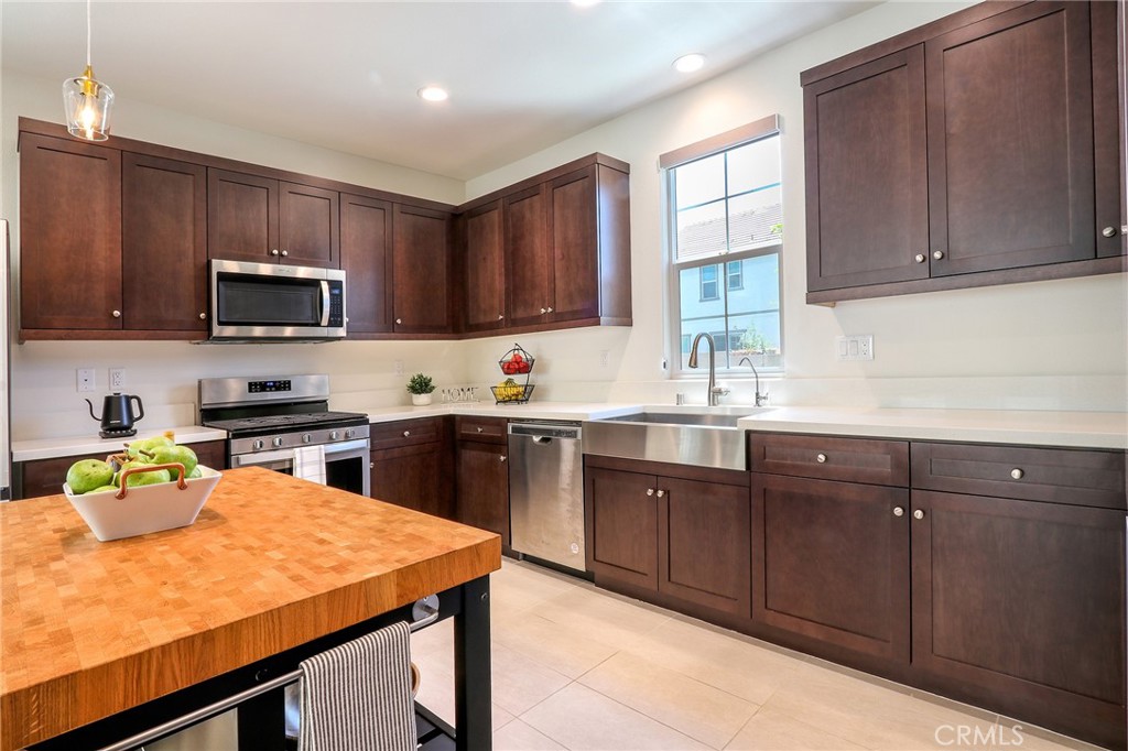 981 Rodeo Road Pomona, CA 91766 - Photo 8 of 47 a kitchen with a sink a stove and cabinets