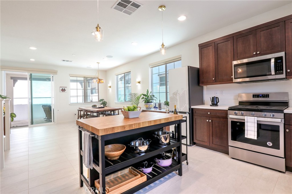 981 Rodeo Road Pomona, CA 91766 - Photo 9 of 47 a kitchen with stainless steel appliances granite countertop a stove a sink and a microwave