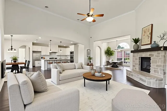 a living room with furniture kitchen view and a fireplace