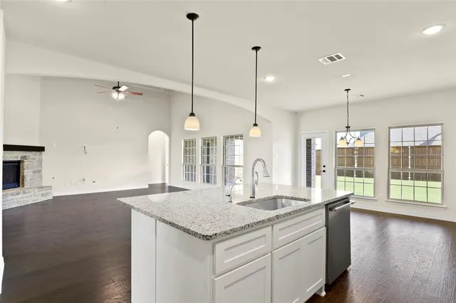 a bedroom with furniture and a large window