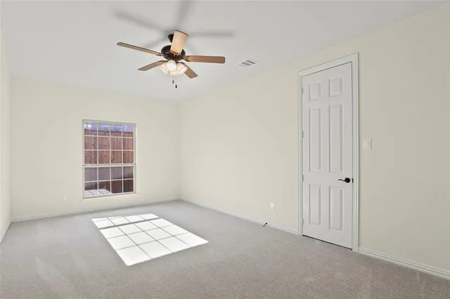 a view of a livingroom with a ceiling fan and window
