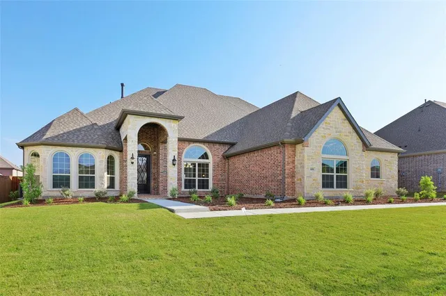 a front view of house with yard and green space