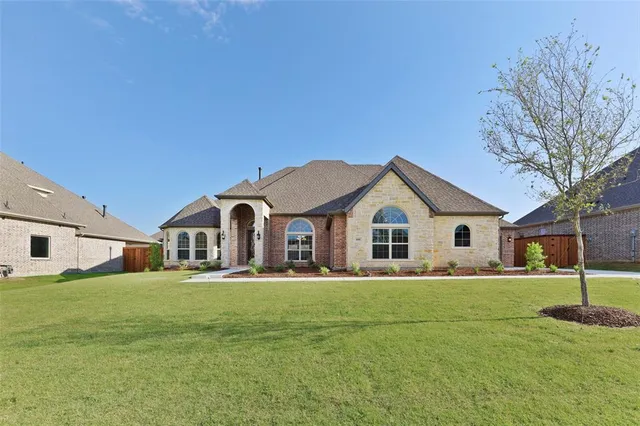 a big house with a big yard and large trees