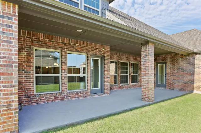 a view of a terrace with lawn chairs