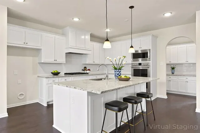 a kitchen with a sink a counter space appliances and cabinets