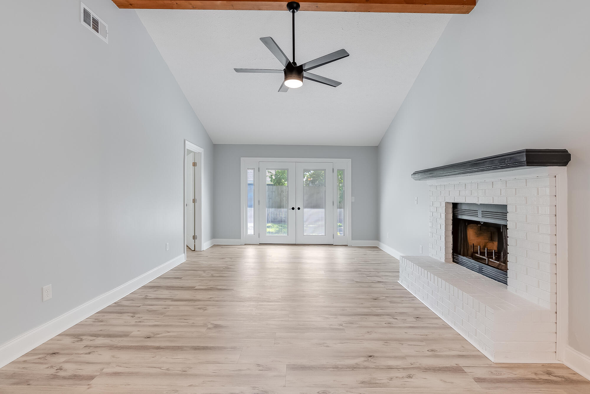 1307 Calabria Road, Unit 4A Panama City, FL 32405 - Photo 18 of 35 a view of an empty room with a fireplace and a window