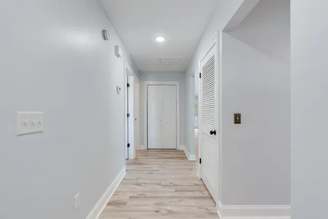 a view of a hallway with wooden floor
