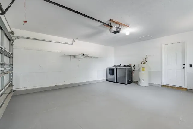 an empty room with a cabinet and mirrors