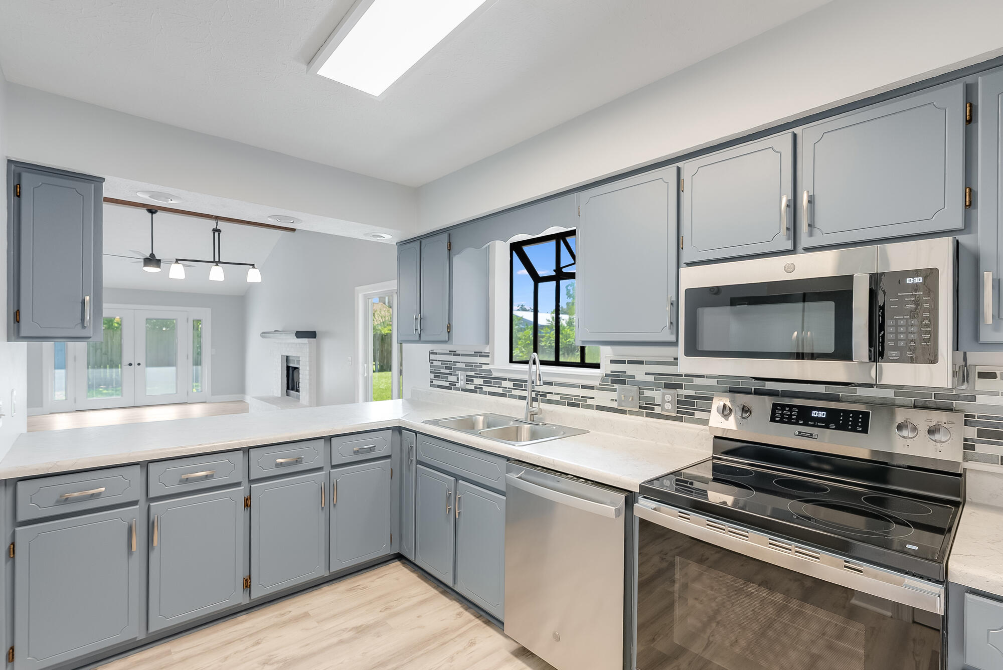 1307 Calabria Road, Unit 4A Panama City, FL 32405 - Photo 10 of 35 a kitchen with a sink stove and microwave