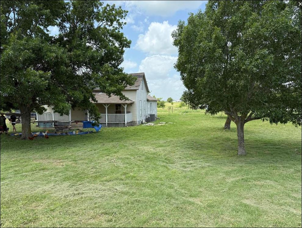 18543 Cyclone Branch Road Burlington, TX 76519 - Photo 11 of 13 a view of a house with a backyard