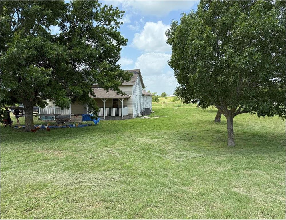 18543 Cyclone Branch Road Burlington, TX 76519 - Photo 13 of 13 a view of a house with a big yard and large trees
