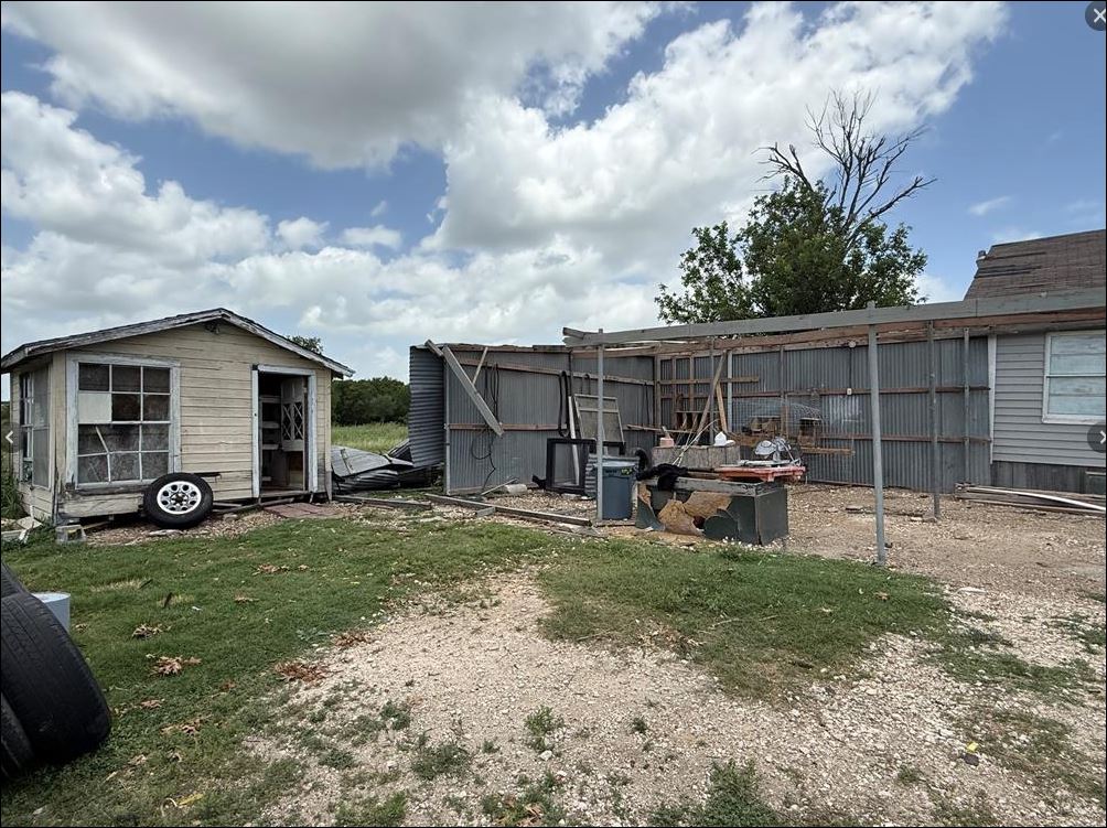 18543 Cyclone Branch Road Burlington, TX 76519 - Photo 2 of 13 a view of a house with backyard and sitting area