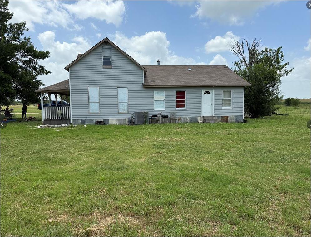 18543 Cyclone Branch Road Burlington, TX 76519 - Photo 4 of 13 a brick house with a yard