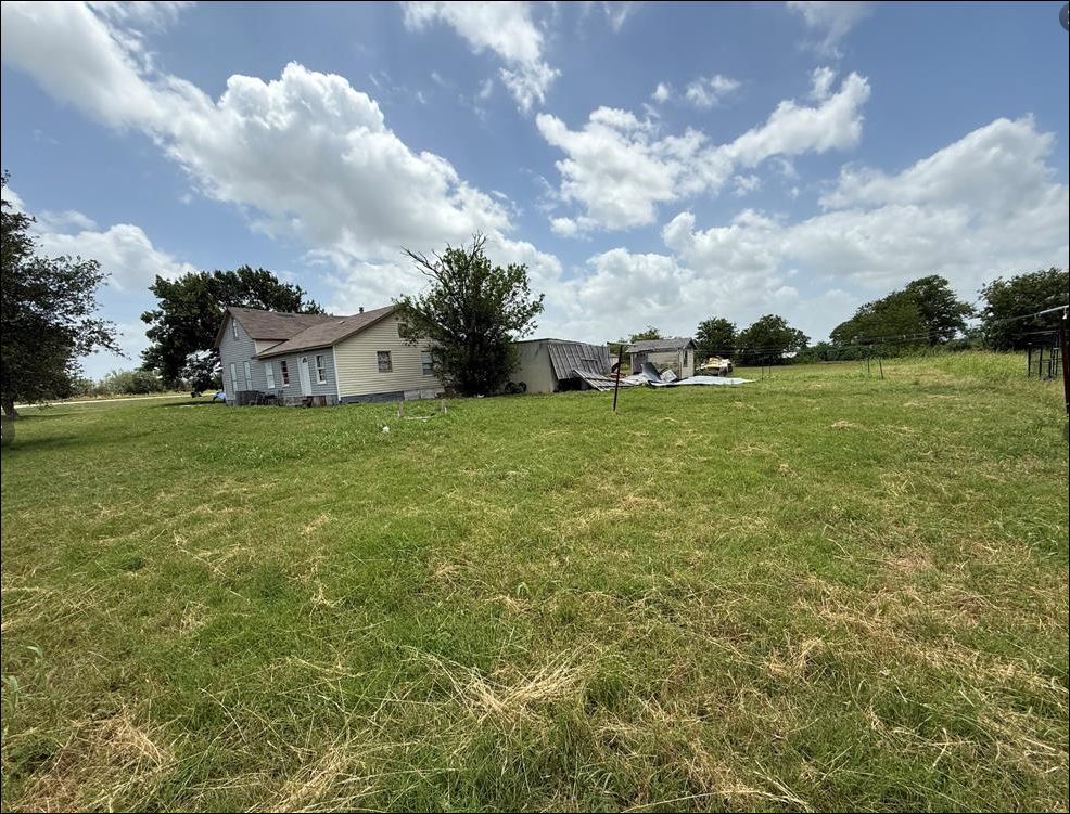 18543 Cyclone Branch Road Burlington, TX 76519 - Photo 5 of 13 a backyard of a house with lots of green space