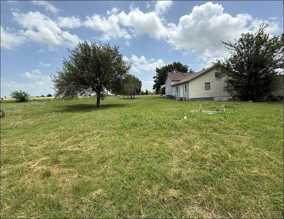 18543 Cyclone Branch Road Burlington, TX 76519 - Photo 6 of 13 a view of a house with a big yard and a large tree