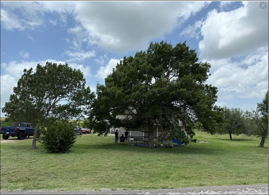 18543 Cyclone Branch Road Burlington, TX 76519 - Photo 10 of 13 a backyard of a house with lots of green space
