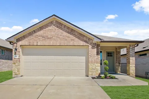 a front view of house with yard and trees