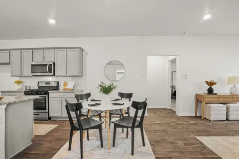 a view of a dining room with furniture and wooden floor