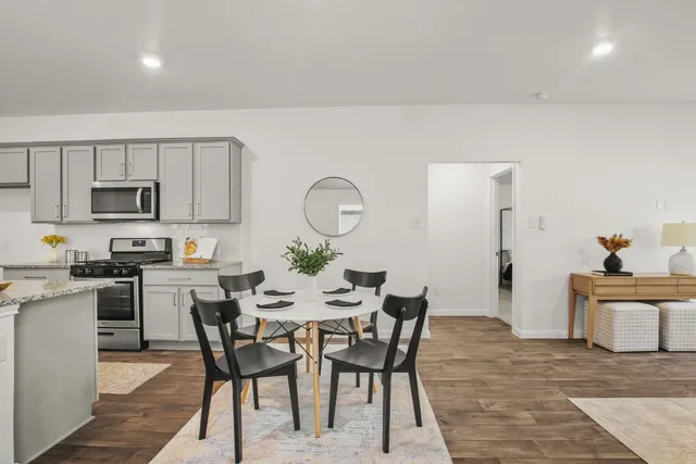a view of a dining room with furniture and wooden floor