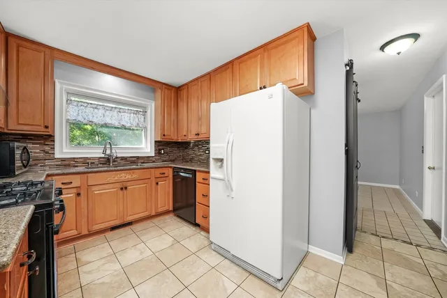 a kitchen with a refrigerator a sink and dishwasher