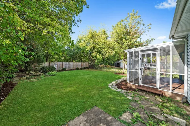 a view of a house with backyard and porch