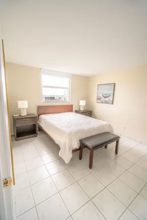 a bedroom with a bed and a dresser