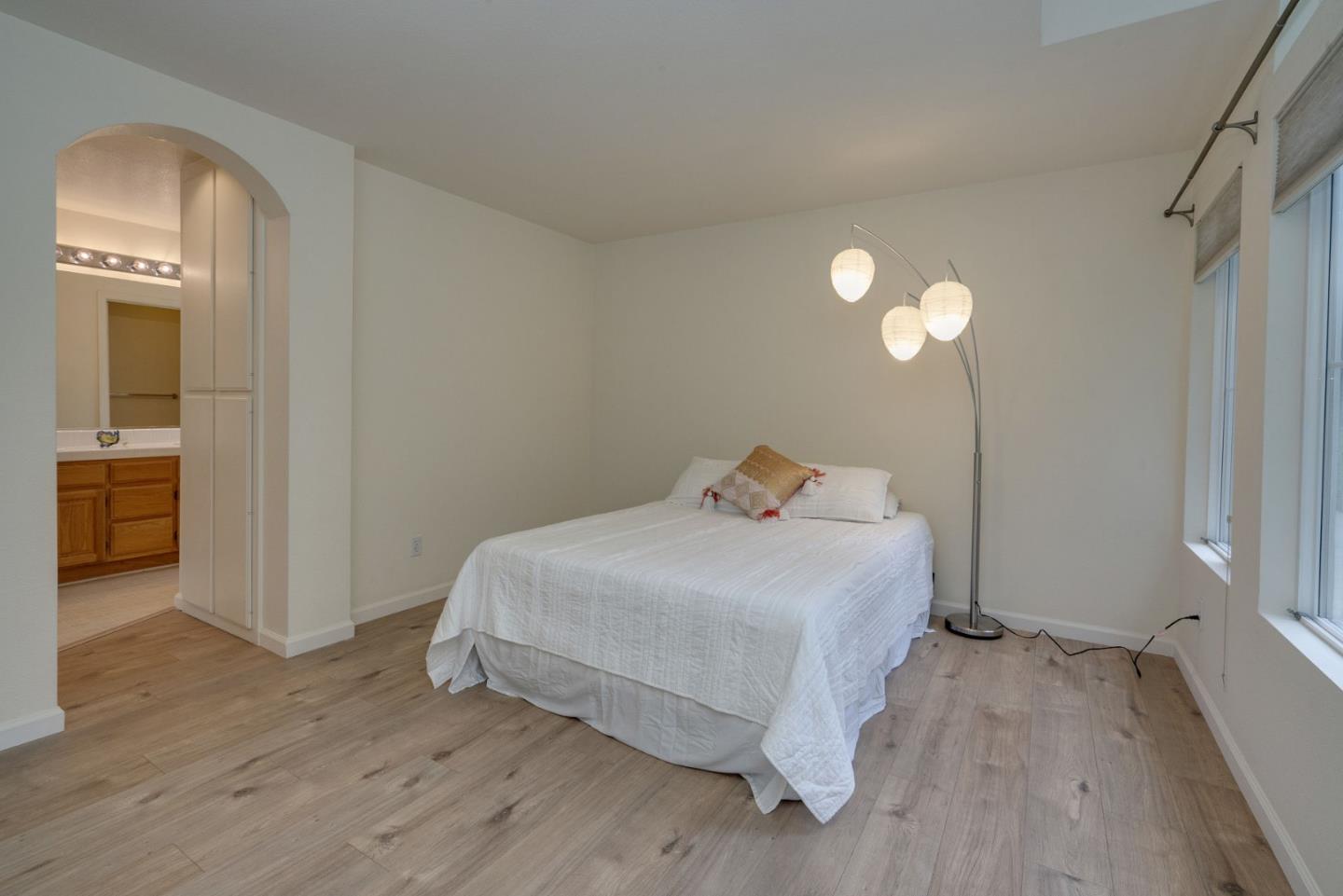 120 Patrick Way Half Moon Bay, CA 94019 - Photo 13 of 23 a bedroom with a bed and a chandelier