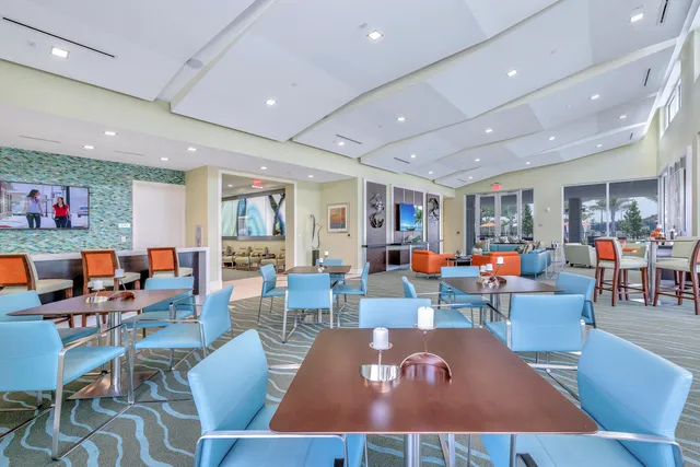 a living room with lots of furniture kitchen view and a dining table