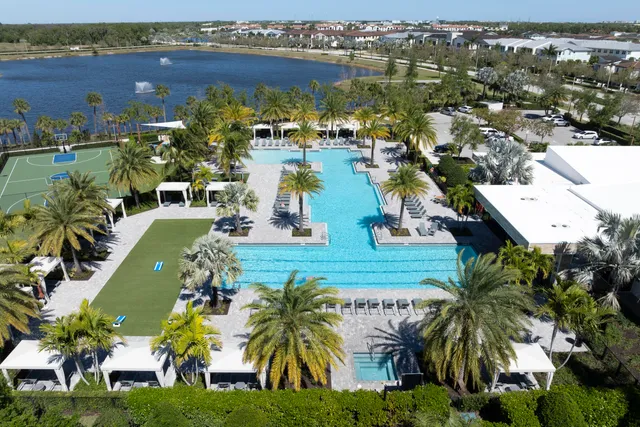 an aerial view of residential houses with outdoor space and swimming pool