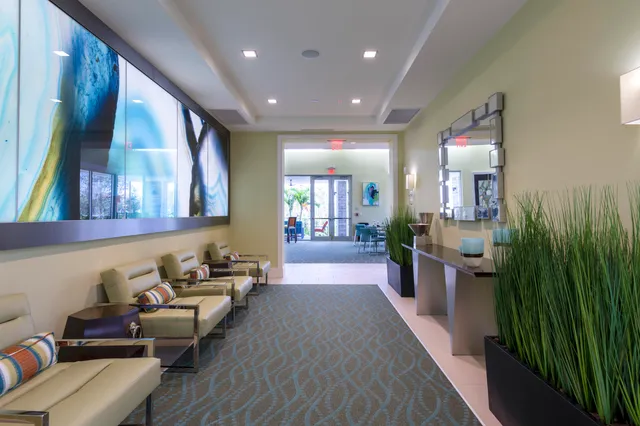 a lobby with furniture and rug