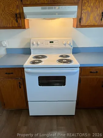 a stove top oven sitting inside of a kitchen